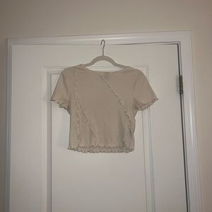 Cream colored shirt with textured lines. Cropped if tall. Wild fable medium